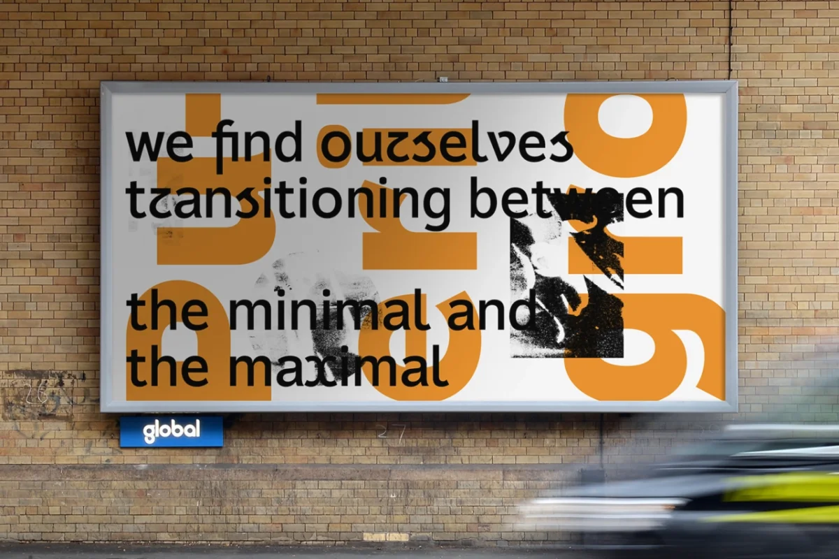 Outdoor billboard on a brick wall displaying text about transitioning between minimal and maximal design with large orange geometric shapes and a small black and white photograph