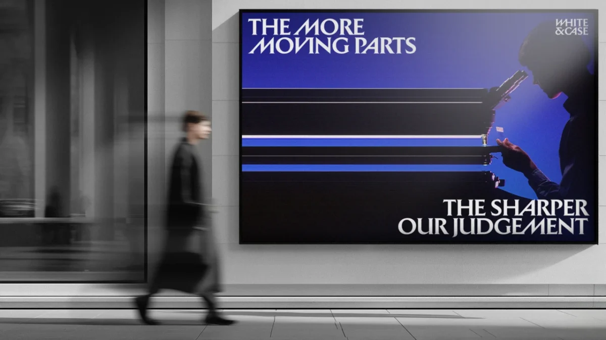 A blurred figure walks past a billboard displaying White & Case's rebrand with the tagline "The More Moving Parts, The Sharper Our Judgement" in Catalyst Blue and black typography