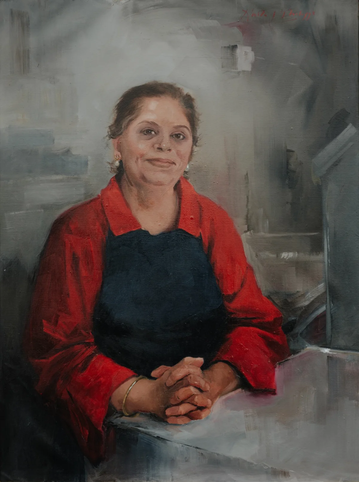 Woman wearing a red jacket over a dark apron, sitting with hands clasped, painted by portrait artist Nicky Philipps